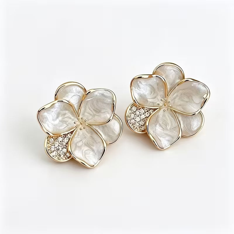 Close-up of the flower-shaped pearl stud earrings