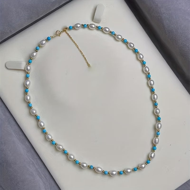 Close-up of the hand-strung pearl and turquoise beads