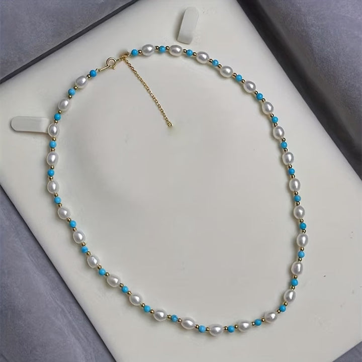 Close-up of the hand-strung pearl and turquoise beads