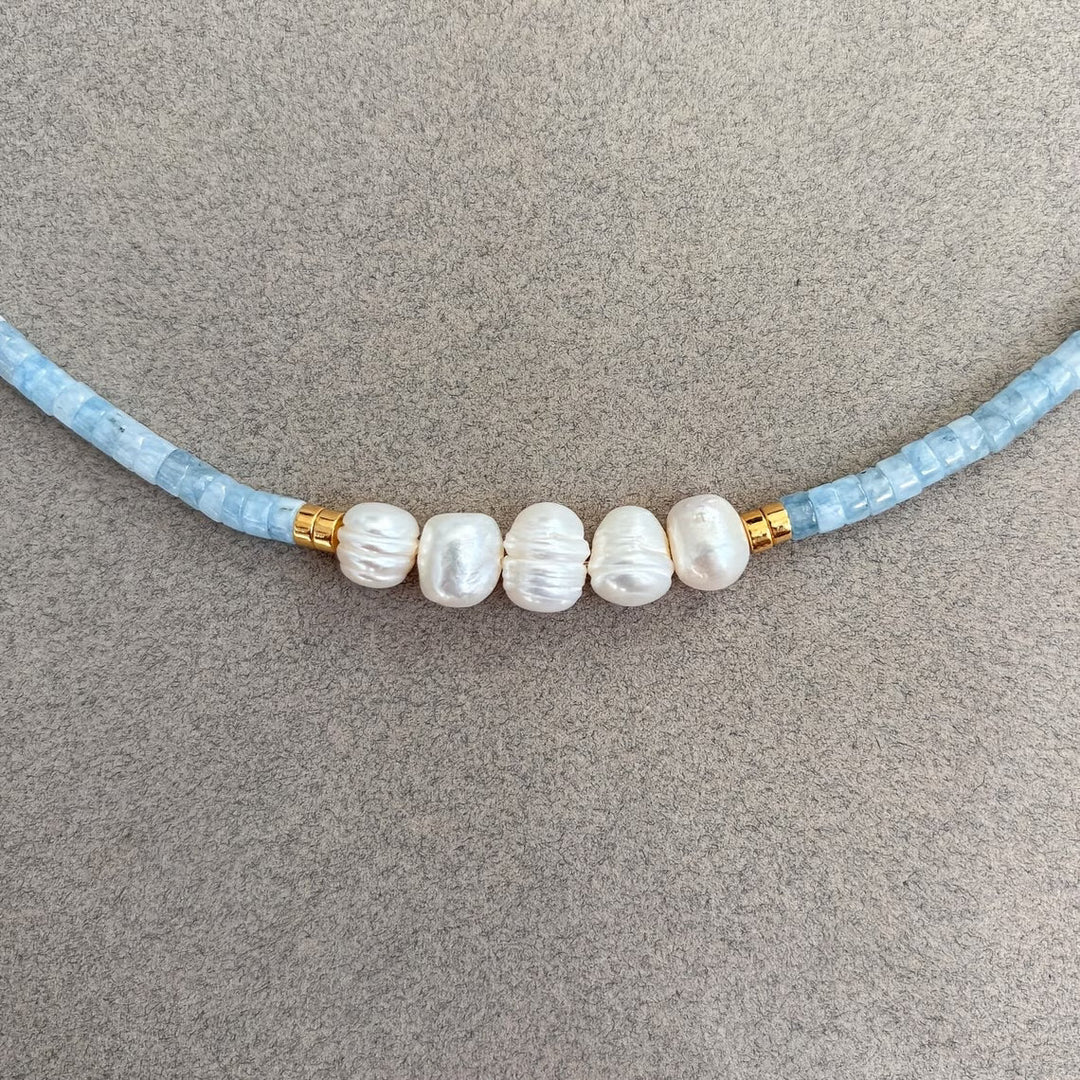 Model wearing the necklace with a simple neckline