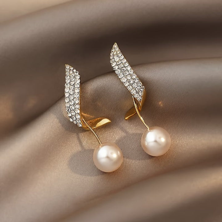Crystal plume pearl earrings shown in close-up product view
