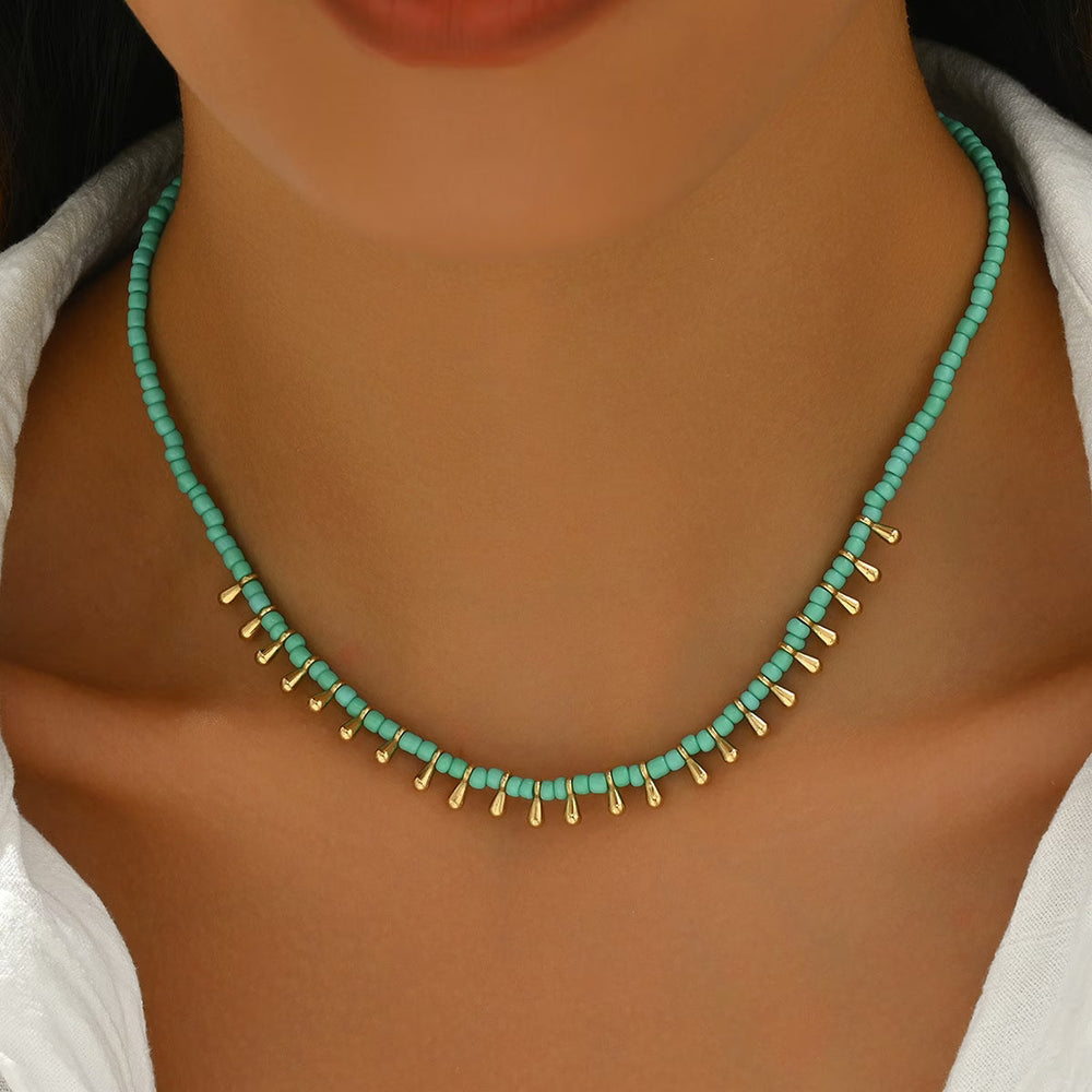 Close-up of the turquoise pendant on the gold-tone chain