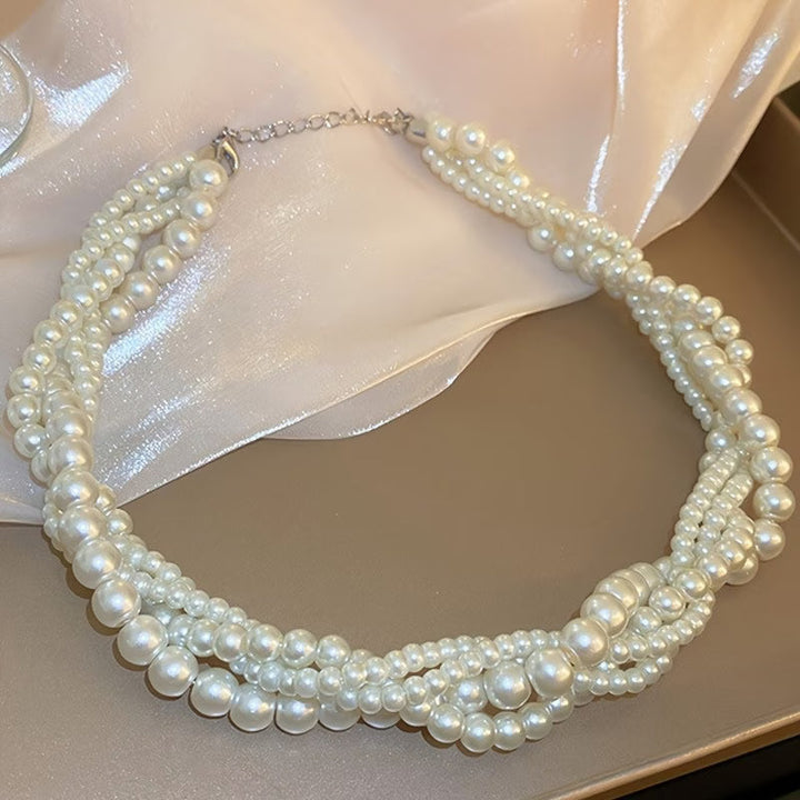 Model wearing the statement pearl necklace with a fitted top