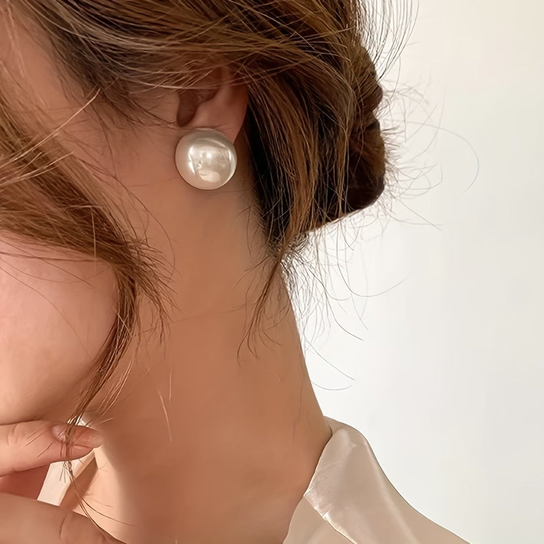 Model wearing the statement pearl stud earrings