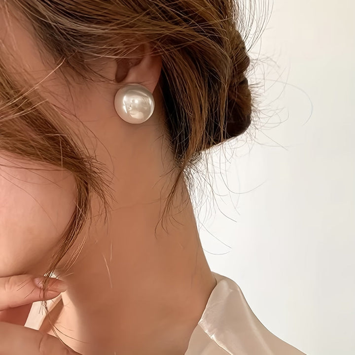 Model wearing the statement pearl stud earrings