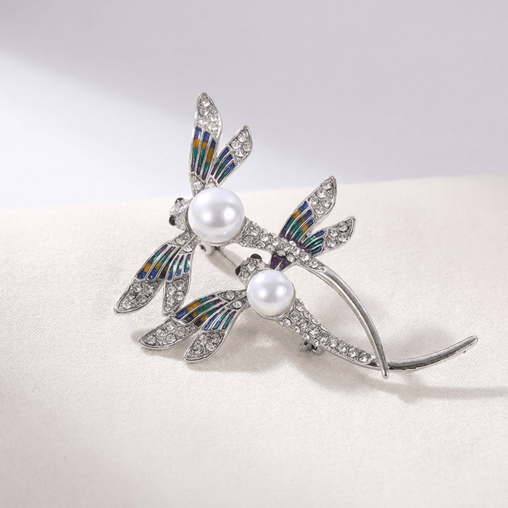Close-up of the pearl-studded dragonfly wings and pin clasp