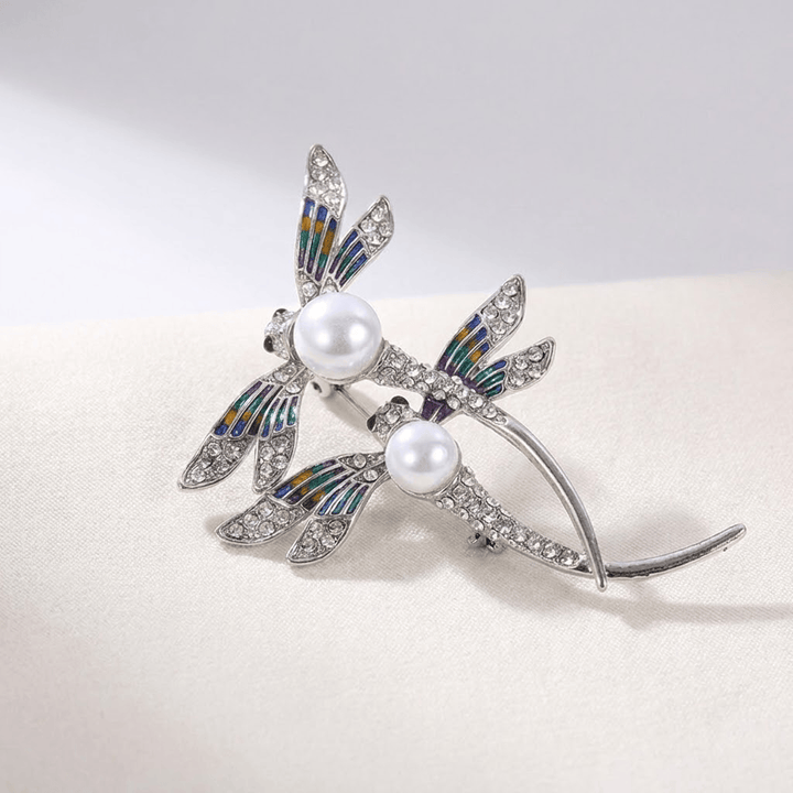 Close-up of the pearl-studded dragonfly wings and pin clasp
