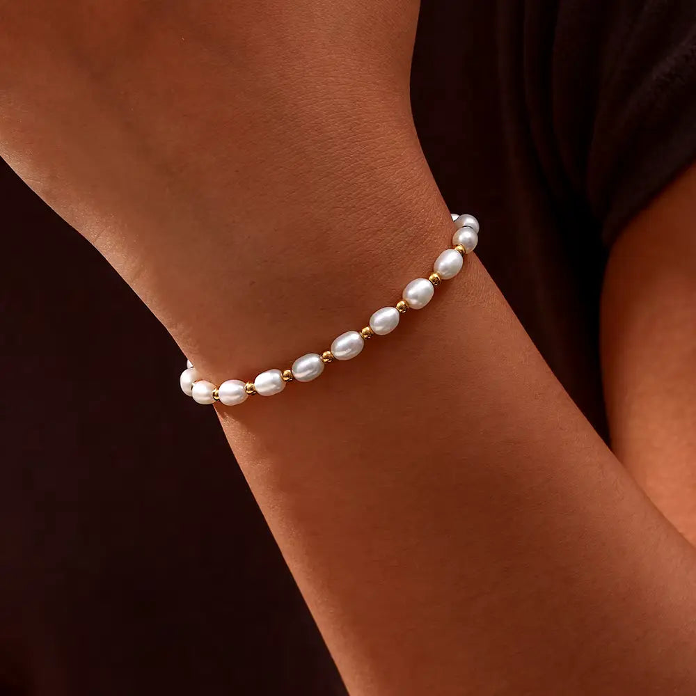 Close-up of gold-tone spacer beads set between the pearls