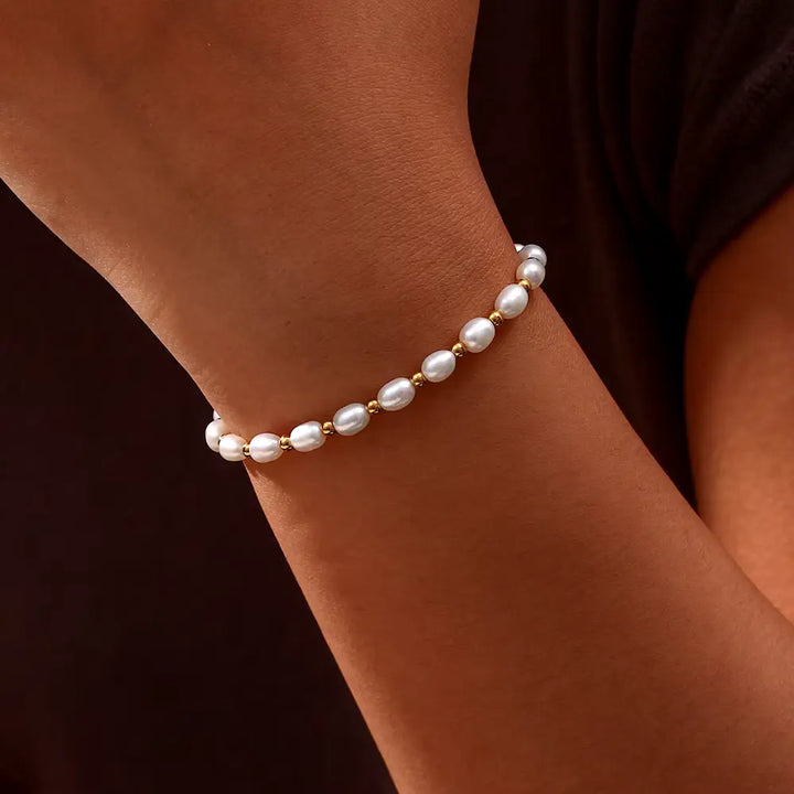 Close-up of gold-tone spacer beads set between the pearls