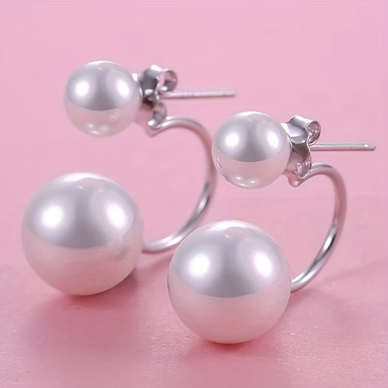 Model wearing the double pearl statement earrings