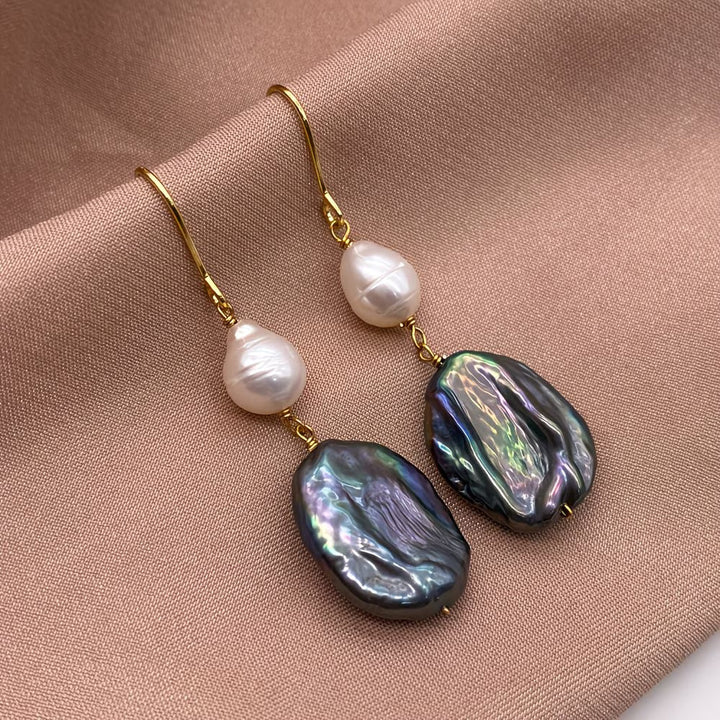 Peacock pearl drop earrings shown together on a white background