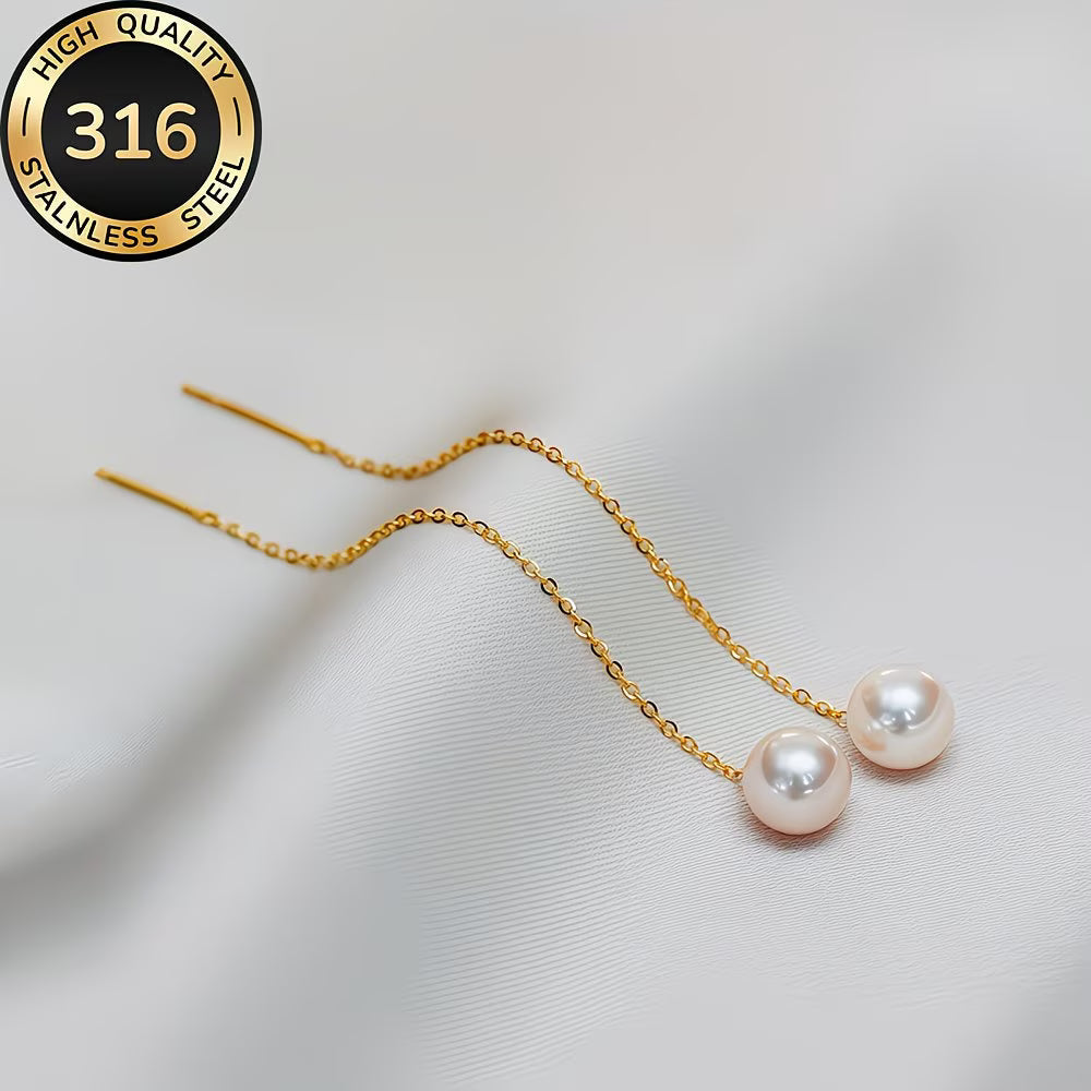 Long tassel pearl earrings laid flat on a white background