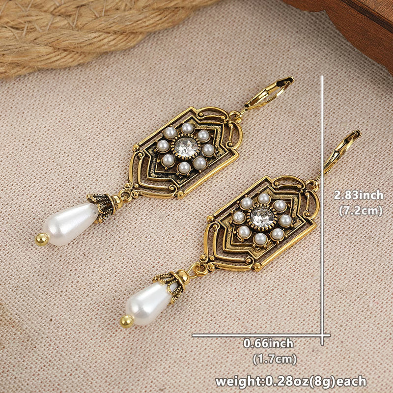 Vintage golden inlaid pearl earrings displayed as a matching pair