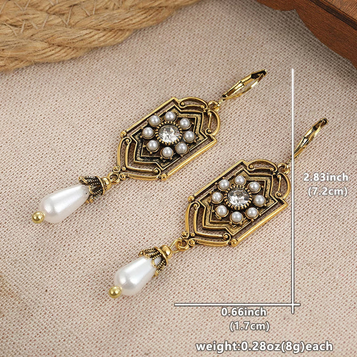 Vintage golden inlaid pearl earrings displayed as a matching pair