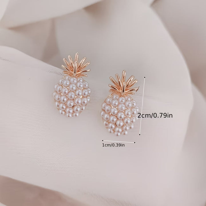 Model wearing the pearl pineapple earrings for scale and styling
