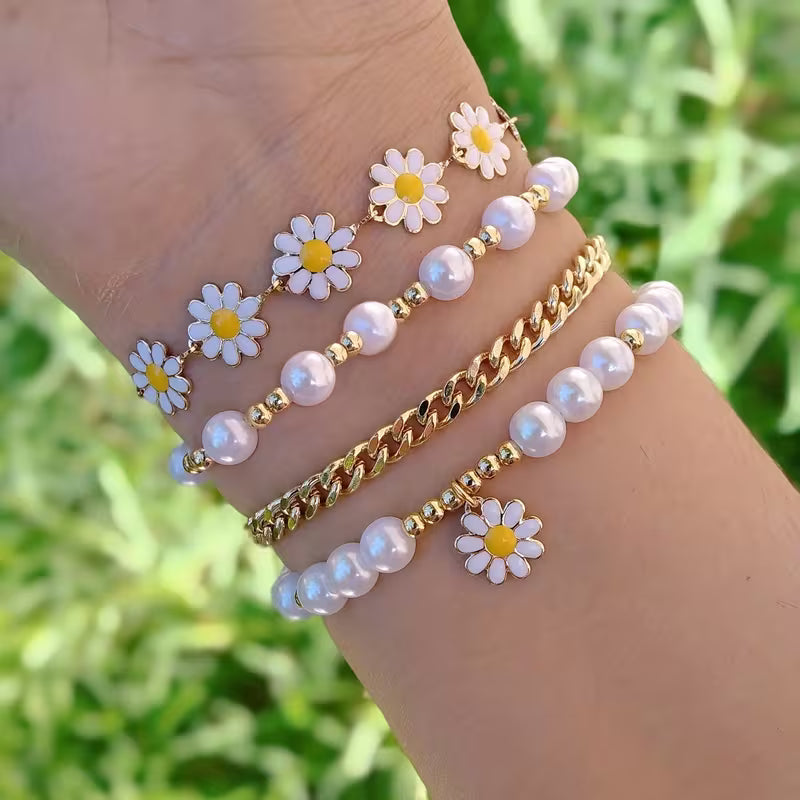 Pearl daisy stacking bracelet set of four laid flat