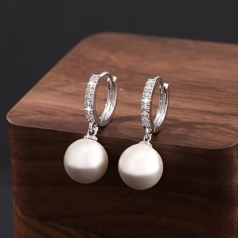 Model wearing the modern pearl drop earrings for a lifestyle shot