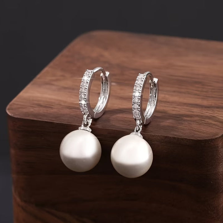 Model wearing the modern pearl drop earrings for a lifestyle shot