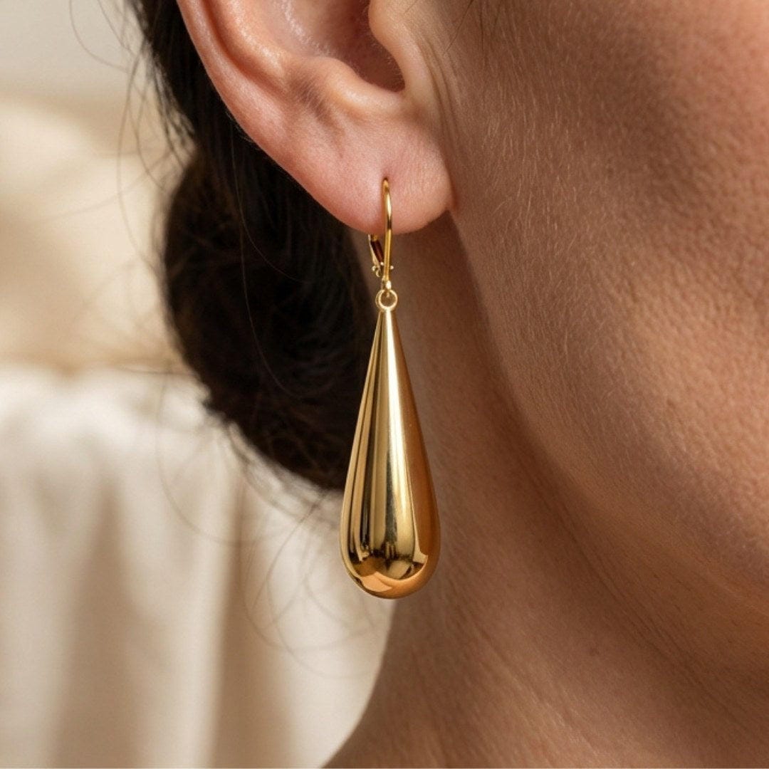 Main shot of the long teardrop gold earrings