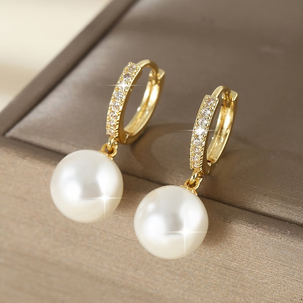 Close-up of the pearl drop earring showing the slim gold-tone post