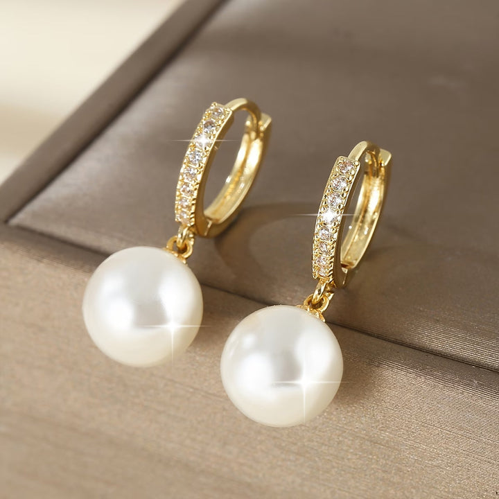 Close-up of the pearl drop earring showing the slim gold-tone post