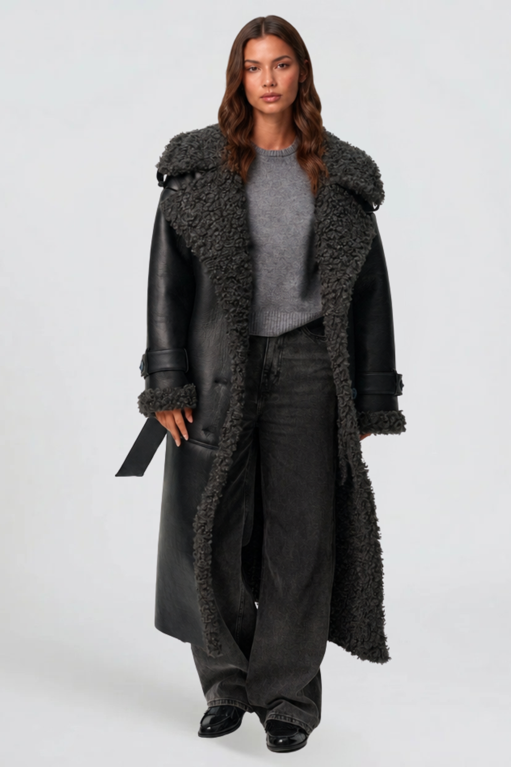 Black leather look shearling coat worn open showing grey teddy lining and wide lapels