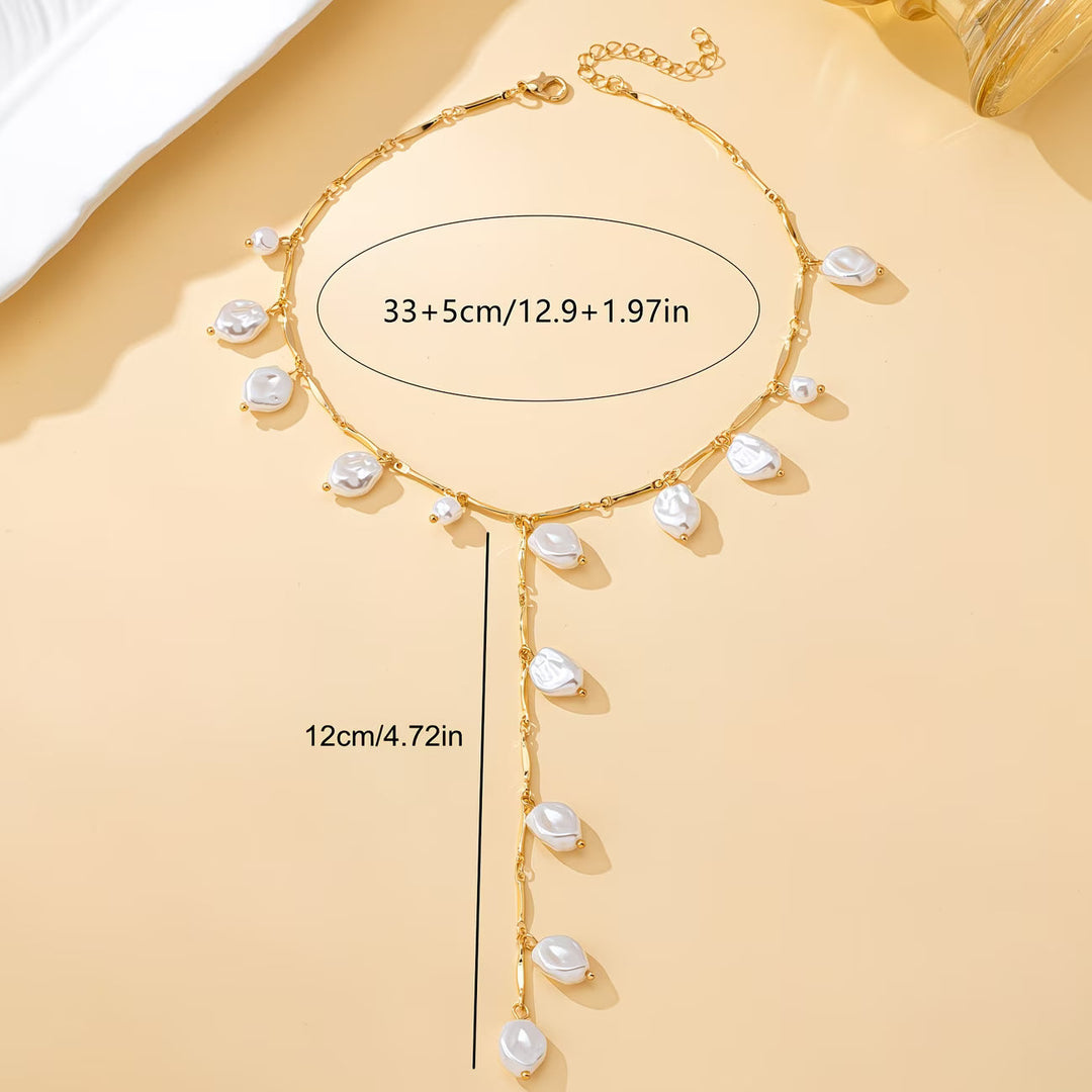 Model wearing the layered pearl necklace against a plain top
