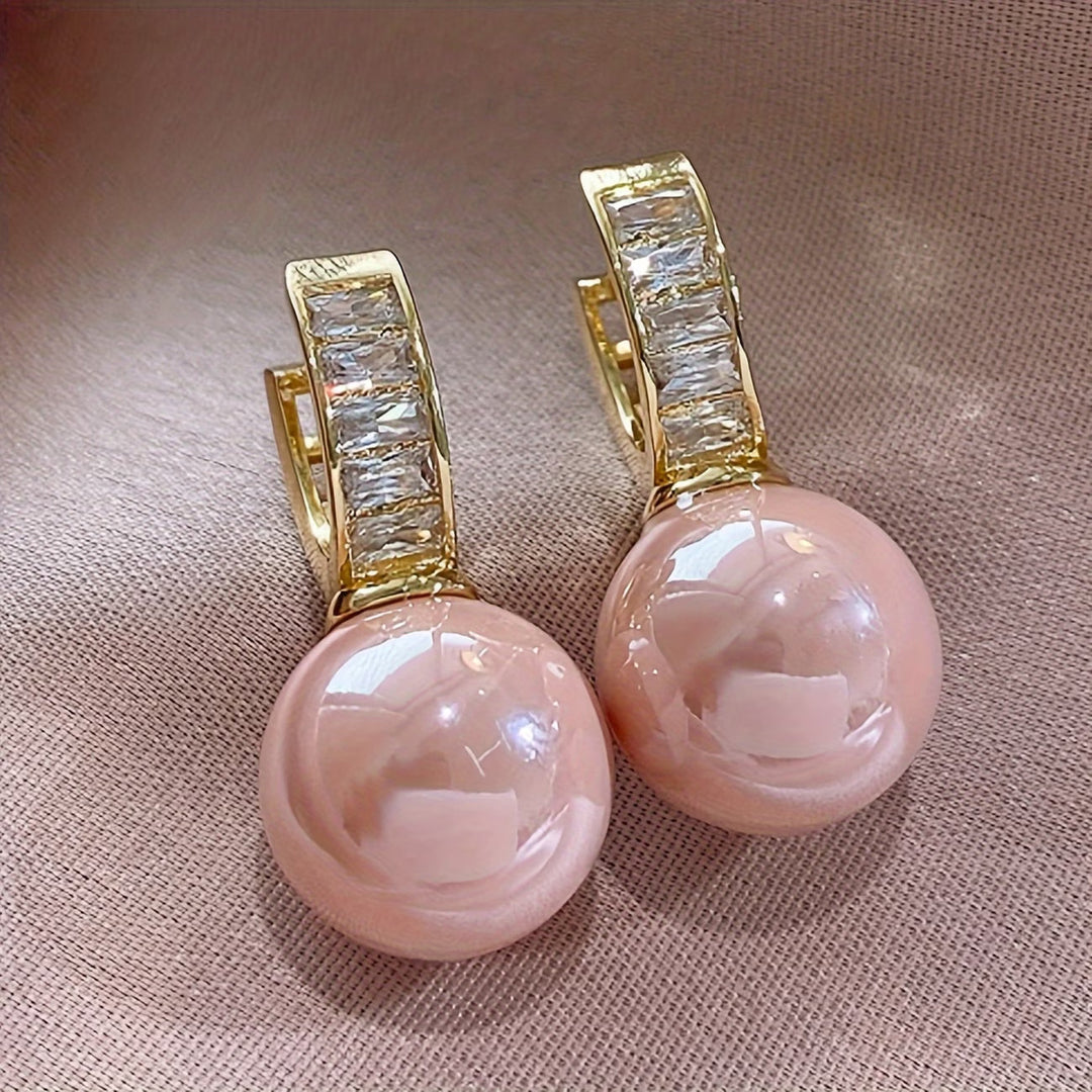 Rose pearl earrings photographed on a white background