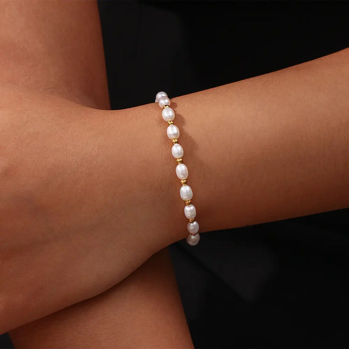 Pearl and gold bracelet shown from a side angle highlighting shine