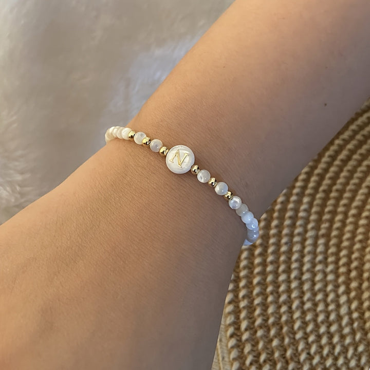 Main shot of the initial pearl charm bracelet
