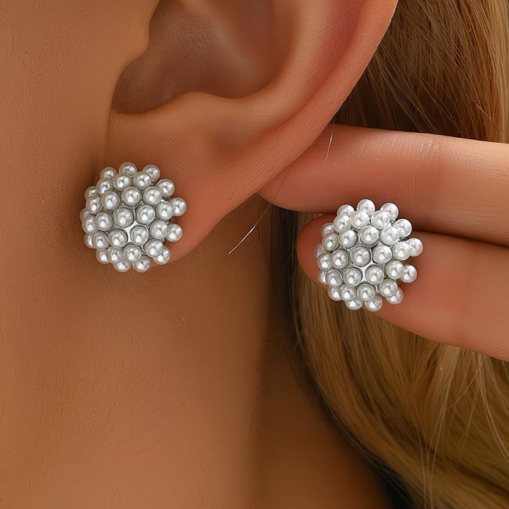 Pearl dome stud earrings shown together on a white background