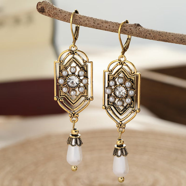 Close-up of the gold-tone frame inlaid with a pearl