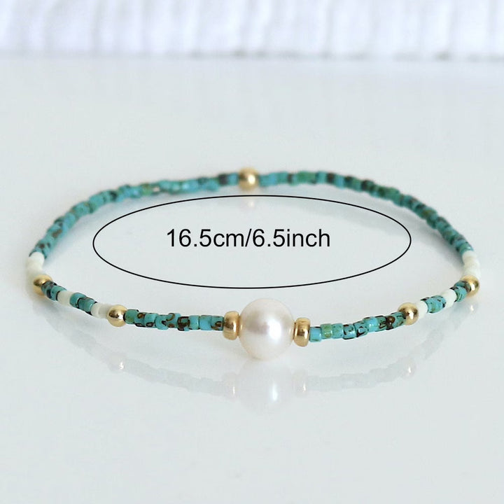 Turquoise pearl bracelet photographed at an angle showing bead texture