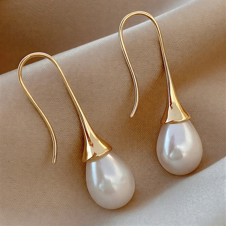 Pearl drop earrings shown on a plain white background