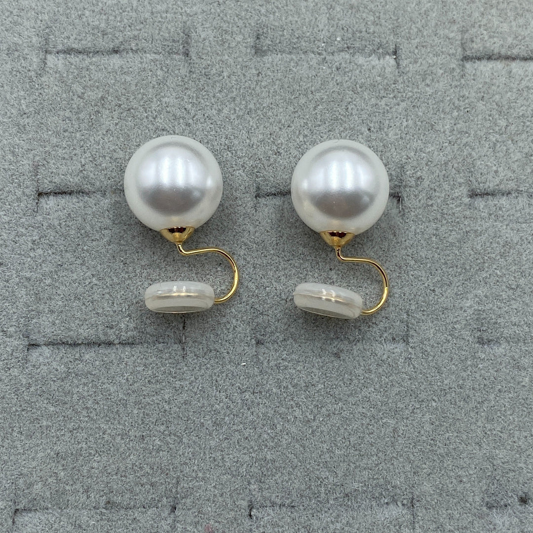 Pair of clip earrings displayed on a soft jewellery pad