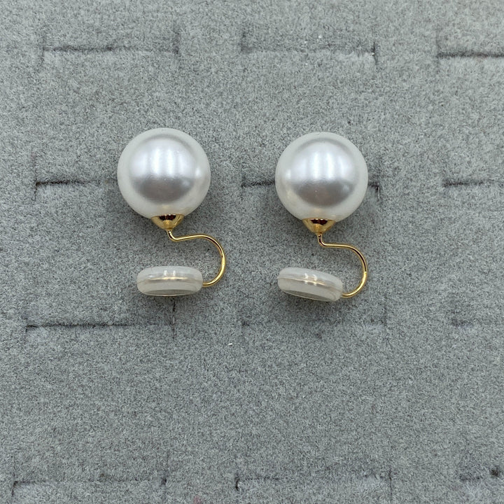 Pair of clip earrings displayed on a soft jewellery pad