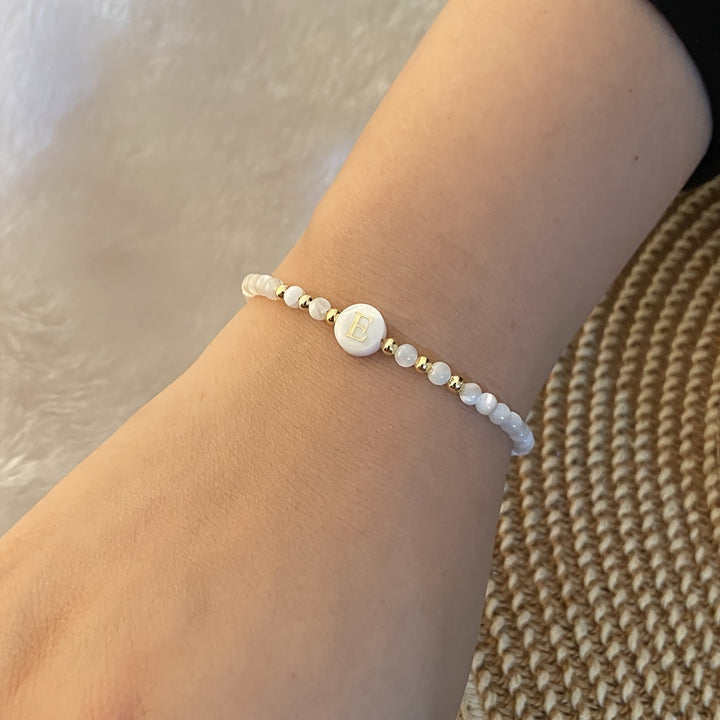 Lifestyle photo of the bracelet stacked with other jewellery