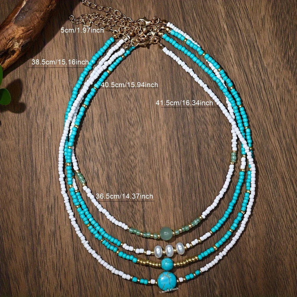 Close-up of the pearl and turquoise beads on one bracelet