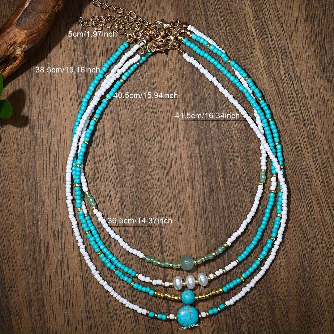 Close-up of the pearl and turquoise beads on one bracelet
