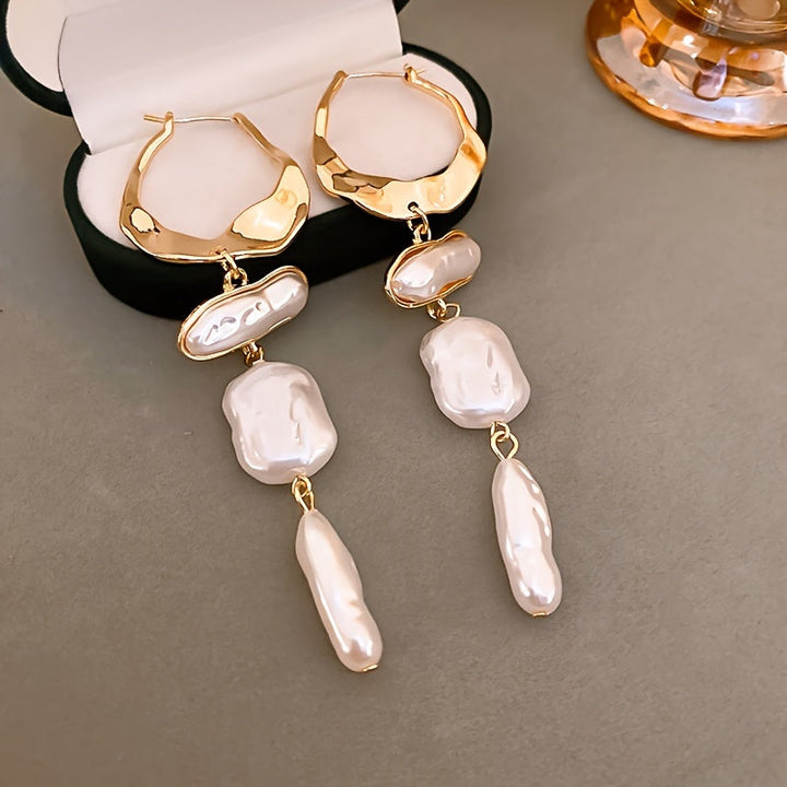 Side profile of a single hoop earring on display