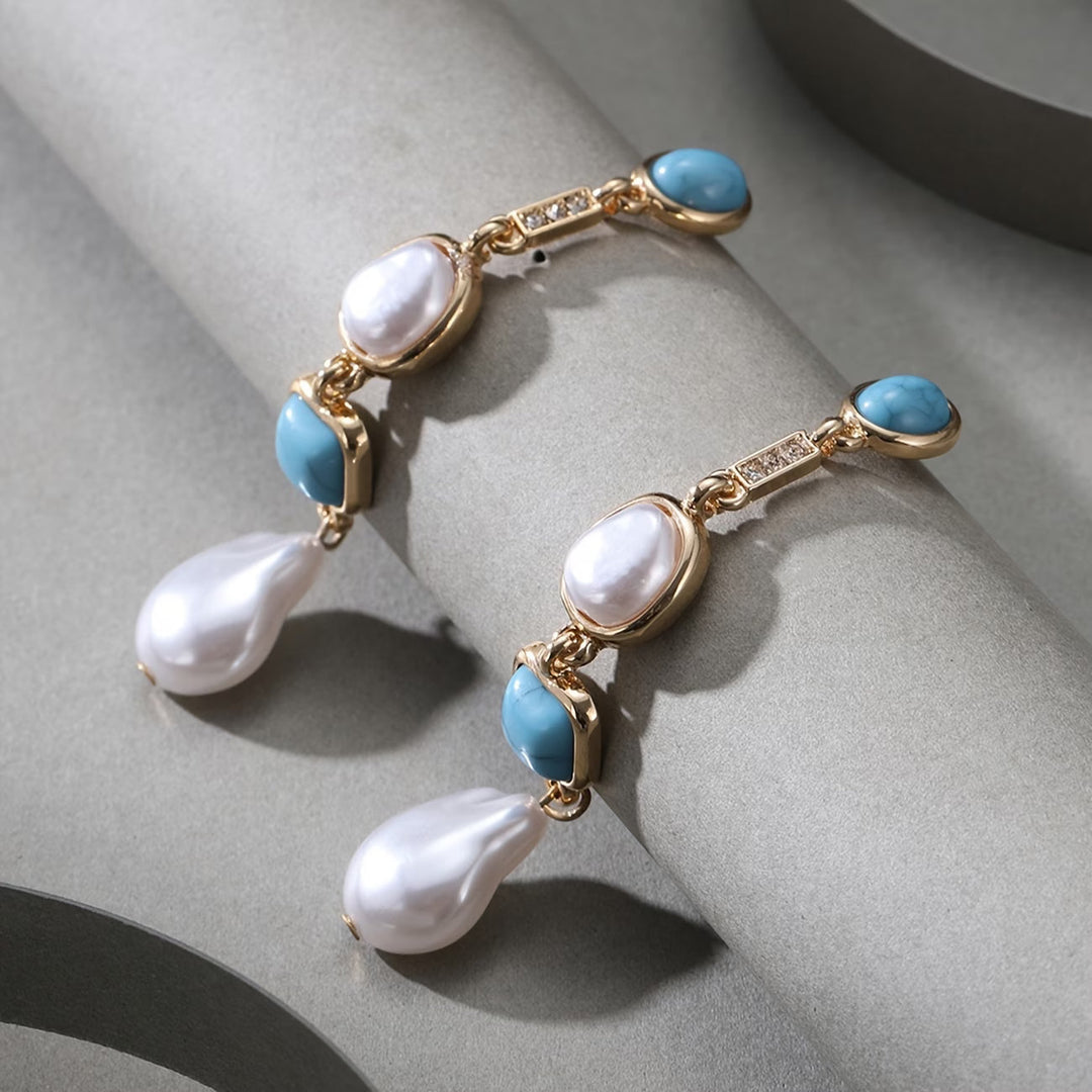 Earrings laid flat on a neutral background