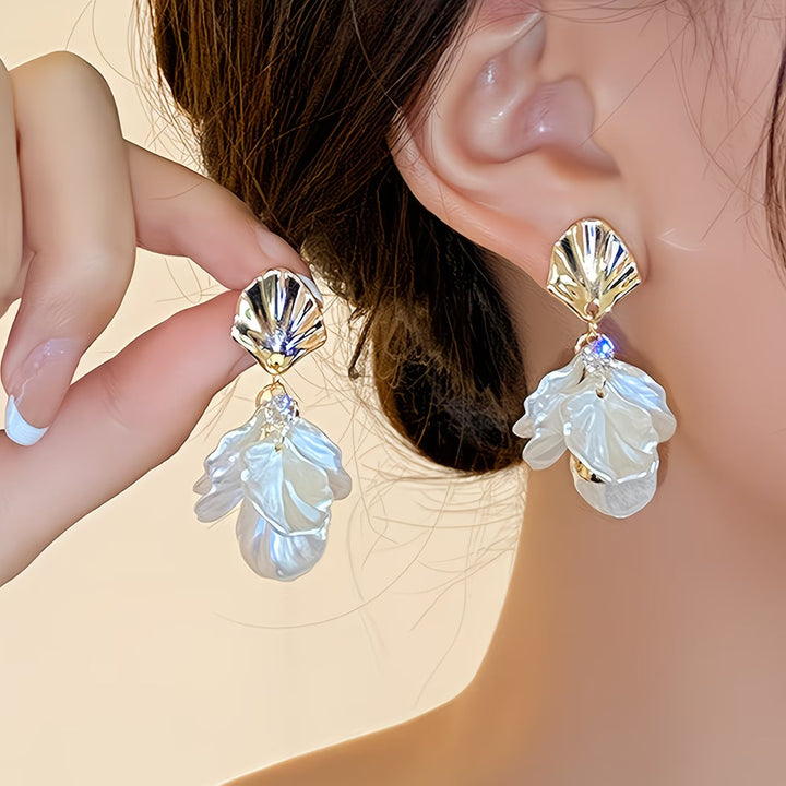 Frosted petal pearl earrings photographed from a side angle