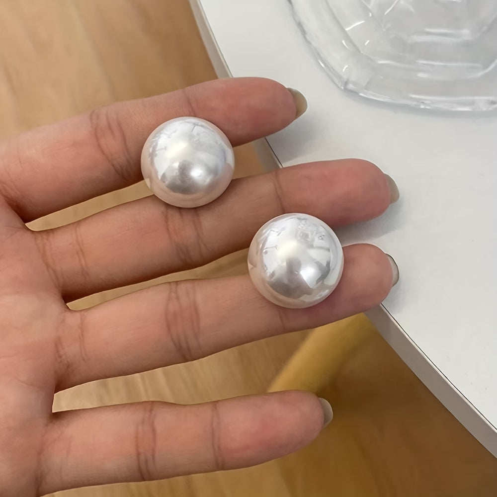 Close-up of the oversized pearl stud detail
