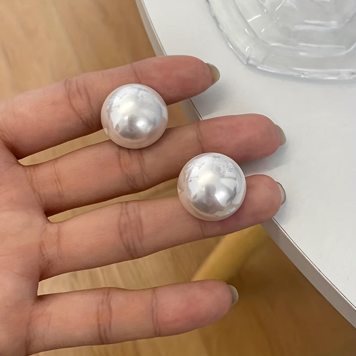 Close-up of the oversized pearl stud detail