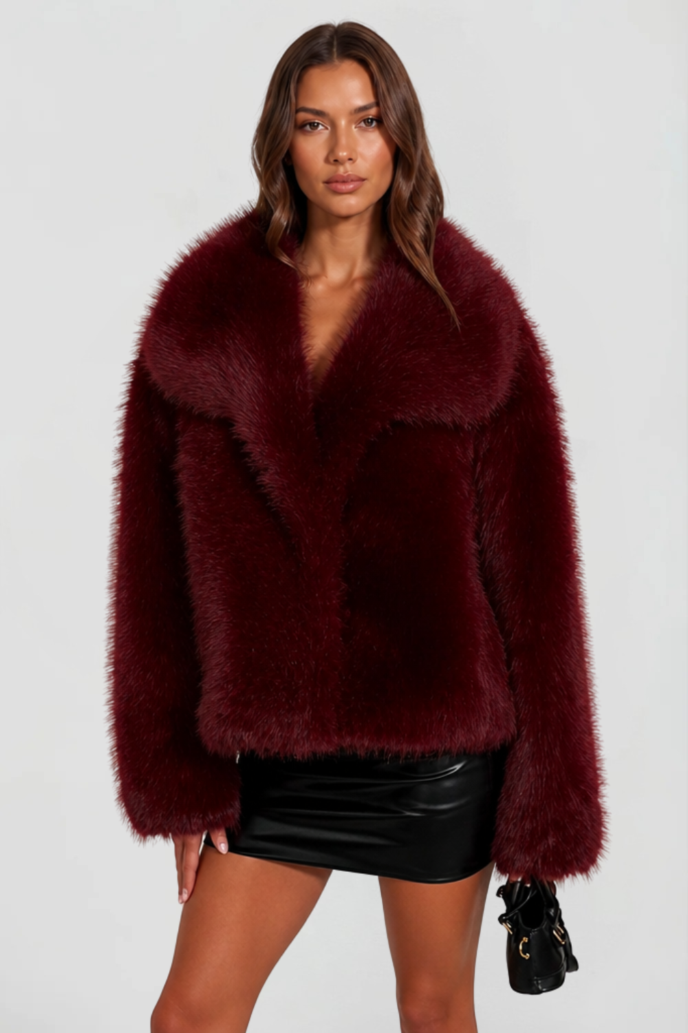 Burgundy shaggy faux fur jacket with wide lapel collar, close front view on model