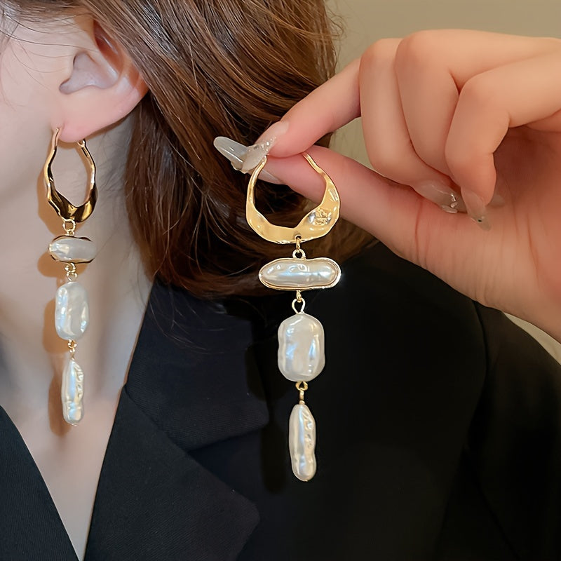 Earrings styled on a model with hair swept back