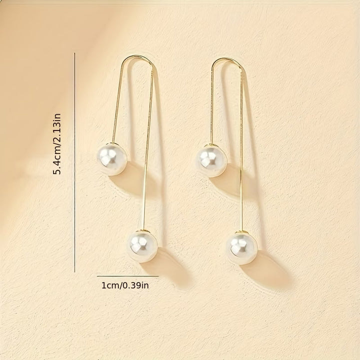 Pearl statement earrings shown from a side angle