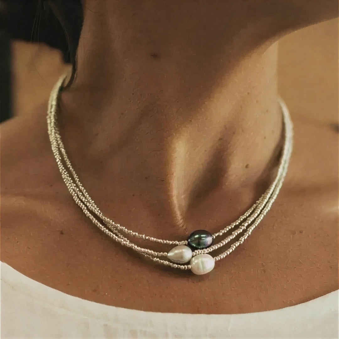 Baroque pearl multi-strand necklace laid flat on a white background