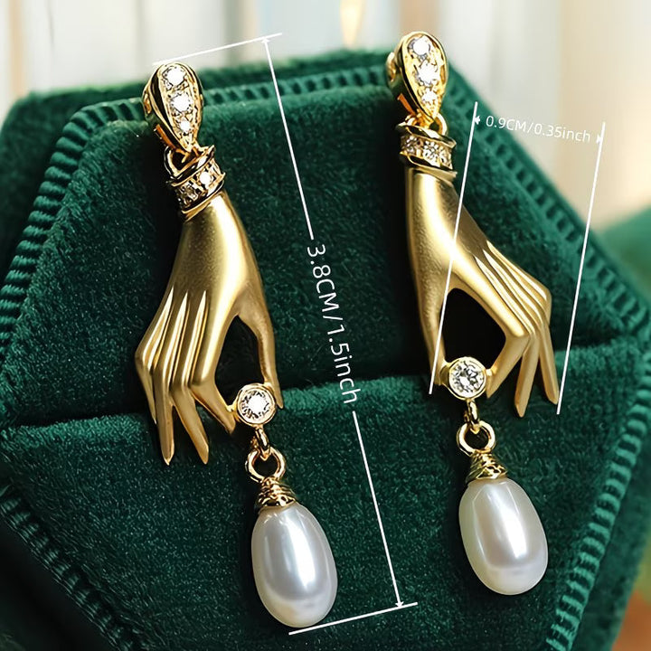 Graceful hand pearl earrings photographed from an angle