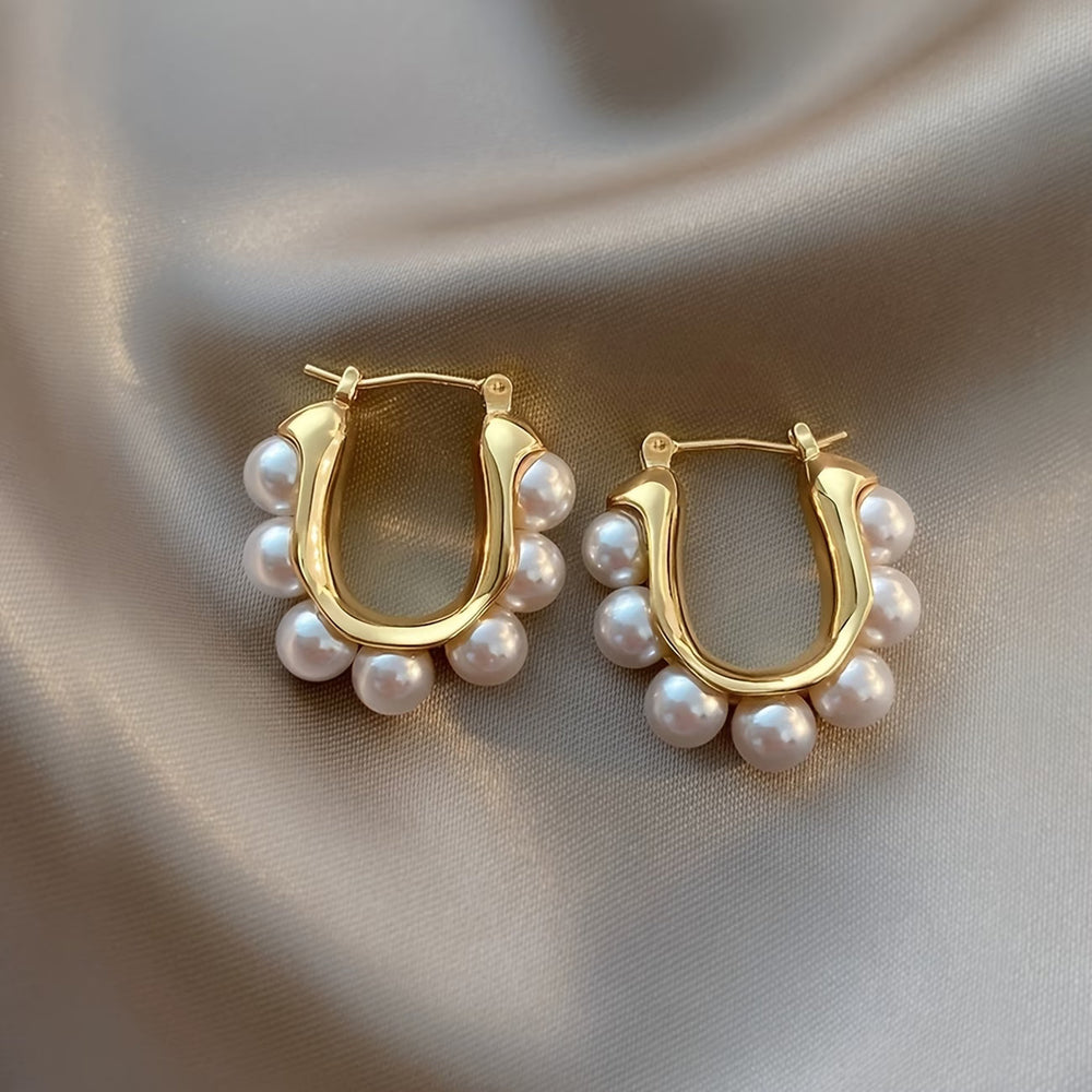 Close-up of the pearl cluster trimming the gold-tone hoop